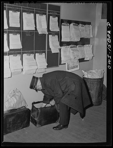 Chicago, Illinois. Conductors and trainmen come to the dispatcher's office of the Union Station for their train orders and to check in