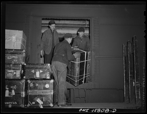 Chicago, Illinois. Unloading baggage from a train that has just come into the Union Station