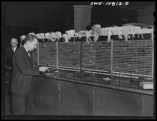 Chicago, Illinois. Making out a baggage receipt for a passenger at the Union Station. The panel is covered with rubber stamps of destination