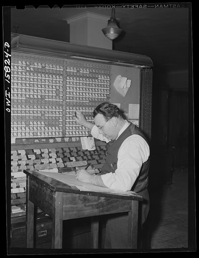 Chicago, Illinois. Ticket seller checking his sales for the day at the Union Station. Each ticket seller has his own ticket rack which he keeps under lock and key. Since each ticket is numbered consecutively, the records are kept by the number of the first and last ticket sold each day. Cash goes to