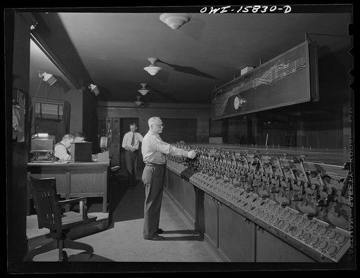Chicago, Illinois. In the interlocking tower at Union Station. It is here that all inbound and outbound traffic is controlled. The men work entirely by the board, hardly ever looking out of a window to see an actual train