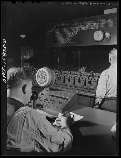 Chicago, Illinois. In the interlocking tower at Union Station. It is here that all inbound and outbound traffic is controlled. The men work entirely by the board, hardly ever looking out of a window to see an actual train