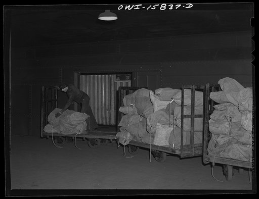 Chicago, Illinois. Loading mail bags into cars at the Union Station. The largest volume of mail in Chicago passes through this station