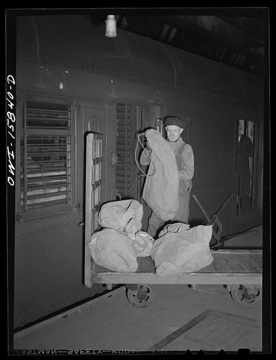 Chicago, Illinois. Lading mail bags into cars at the Union Station. The largest volume of mail in Chicago passes through this station
