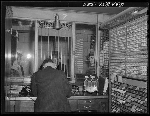 Untitled photo, possibly related to: Chicago, Illinois. In a ticker seller's booth at Union Station