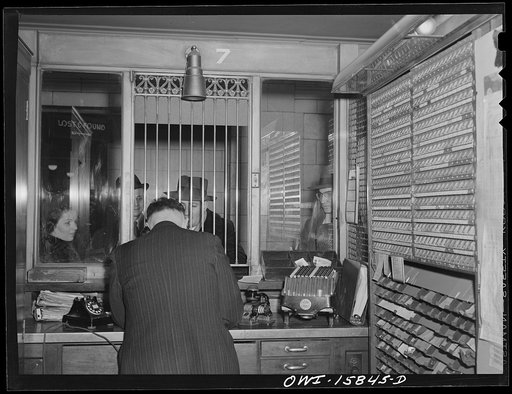 Untitled photo, possibly related to: Chicago, Illinois. In a ticker seller's booth at Union Station