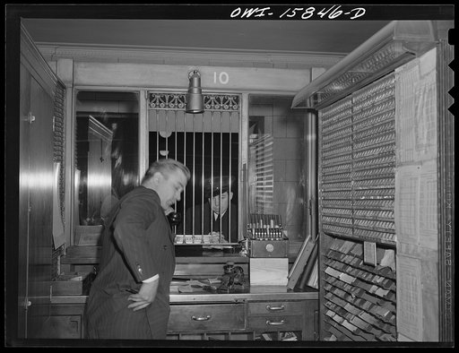 Untitled photo, possibly related to: Chicago, Illinois. In a ticker seller's booth at Union Station
