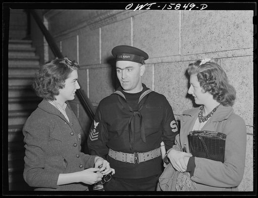 Chicago, Illinois. The Shore Patrol men in the Union Station are all former Chicago policemen. The two young ladies are station employees
