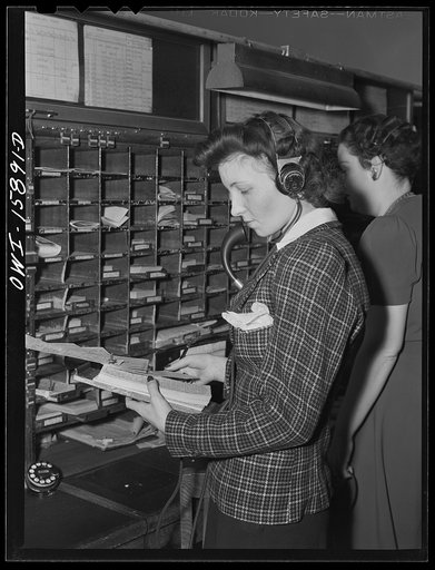 Chicago, Illinois. Reservation girl checking reservation diagrams at the Union Station