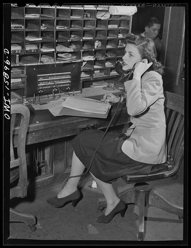 Chicago, Illinois. Reservation girl at the Union Station taking a reservation for a passenger by telephone