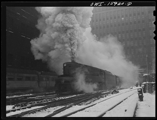 Chicago, Illinois. One of the Pennsylvania Railroad's giant 6100 class engines pulling out of the Union Station on the "Manhattan Limited" run