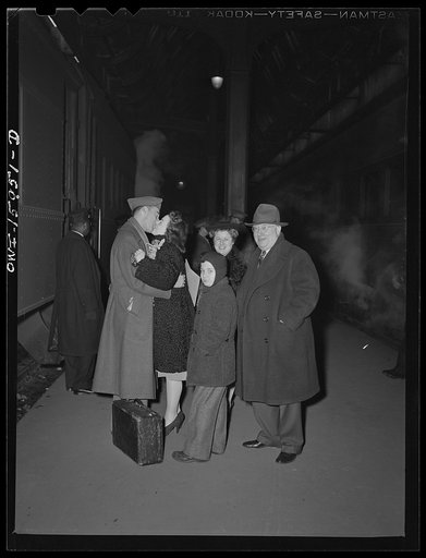 Chicago, Illinois. This couple have just been married and he is returning back to camp from Union Station