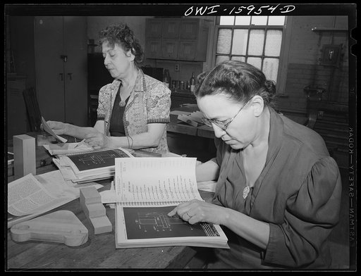 New York, New York. Industrial training for war work offered to women by New York University under United States government sponsorship. The woman in the foreground was a school teacher until she was married ten years ago and became a housewife. The woman in the background was a vaudeville entertain