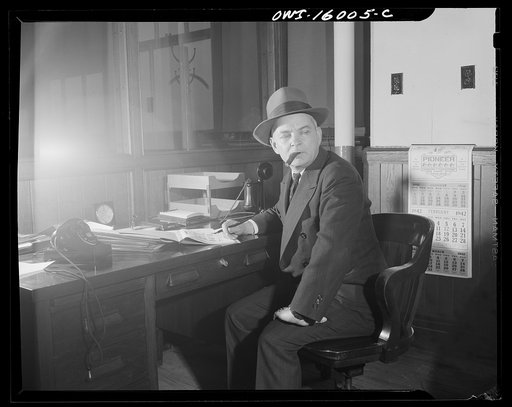 Untitled photo, possibly related to: Detroit, Michigan. Superintendent of the new Chrysler plant in Chicago, lighting a cigar