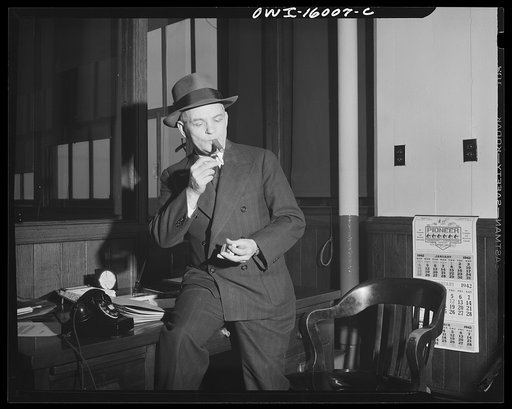 Detroit, Michigan. Superintendent of the new Chrysler plant in Chicago, lighting a cigar