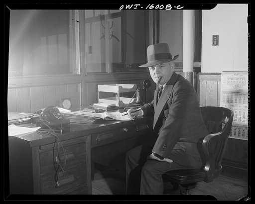 Untitled photo, possibly related to: Detroit, Michigan. Superintendent of the new Chrysler plant in Chicago, lighting a cigar