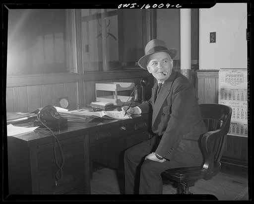 Untitled photo, possibly related to: Detroit, Michigan. Superintendent of the new Chrysler plant in Chicago, lighting a cigar