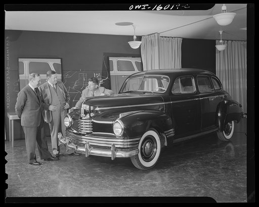 Untitled photo, possibly related to: Detroit, Michigan. Norman Bel Geddes and Nash-Kelvinator corporation officials inspecting a marked-up model of a new car