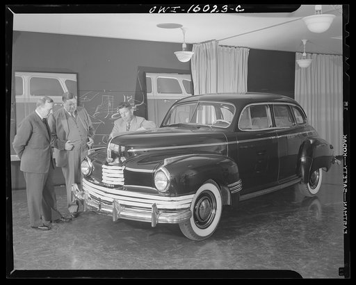 Untitled photo, possibly related to: Detroit, Michigan. Norman Bel Geddes and Nash-Kelvinator corporation officials inspecting a marked-up model of a new car