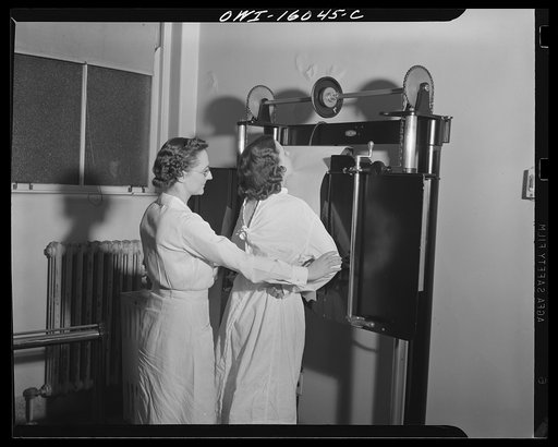 Detroit, Michigan. New method of making x-ray photographs size 4x5 inches instead of larger. Used at the Herman Kiefer Hospital for Communicable Diseases to show various stages of tuberculosis. Placing a patient against an old style x-ray film holder