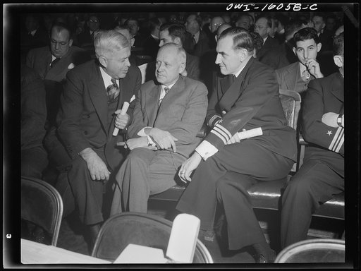 Detroit, Michigan. Charles Wilson of the General Motors Corporation with a Navy man and an unknown manufacturer at an early meeting of the Automobile Council for War Production