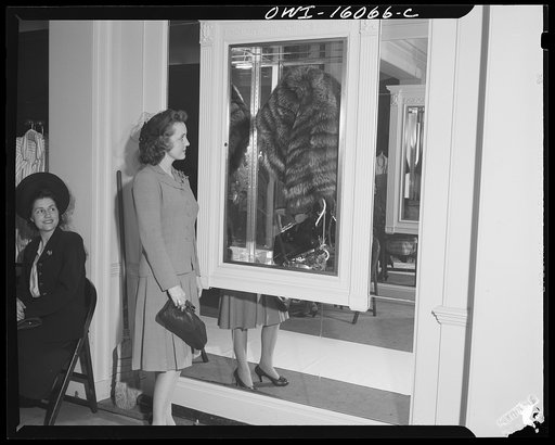 Detroit, Michigan. Style show of clothes worn by better-dressed office workers, presented by the Chrysler Girls' Club of the Chrysler Corporation at Saks Fifth Avenue store. Girl admiring a mink coat
