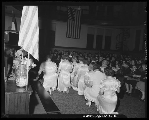 Toledo, Ohio. Evangelical church ceremony at which the preacher delivered a hysterical speech, and then burned a copy of Hitler's Mein Kampf. Sisters of the congregation kneeling in prayer