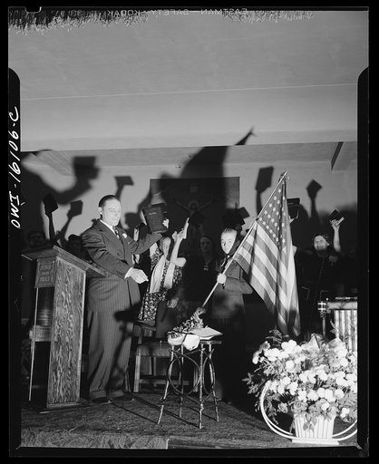 Toledo, Ohio. Evangelical church ceremony at which the preacher delivered a hysterical speech, and then burned a copy of Hitler's Mein Kampf. Preacher with the Bible, Mein Kampf burning, and a boy with the American flag