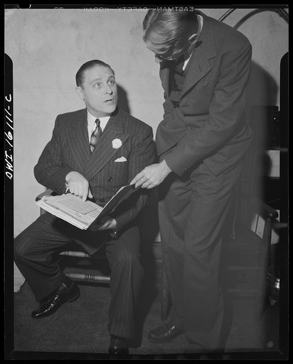 Untitled photo, possibly related to: Toledo, Ohio. Evangelical church ceremony at which the preacher delivered a hysterical speech, and then burned a copy of Hitler's Mein Kampf. Preacher with burned copy of Mein Kampf in one hand and the Bible in the other