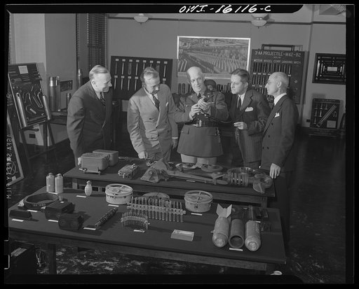 Detroit, Michigan. Conference between U.S. Army ordnance and washing machine industry officials to determine the ability of manufacturers to produce parts needed by the Army. After inspecting samples, blueprints, and prices were discussed. Land mines, trench mortars, gun clips and gas containers are
