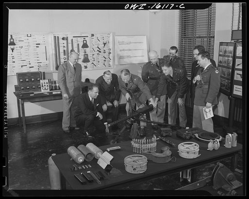 Detroit, Michigan. Conference between U.S. Army ordnance and washing machine industry officials to determine the ability of manufacturers to produce parts needed by the Army. After inspecting samples, blueprints, and prices were discussed. Examining a machine gun