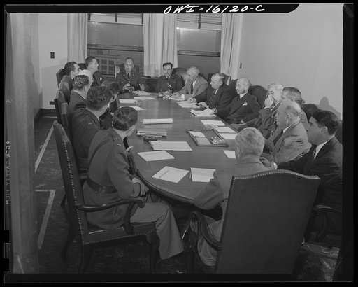 Untitled photo, possibly related to: Detroit, Michigan. Conference between U.S. Army ordnance and washing machine industry officials to determine the ability of manufacturers to produce parts needed by the Army. After inspecting samples, blueprints and prices were discussed