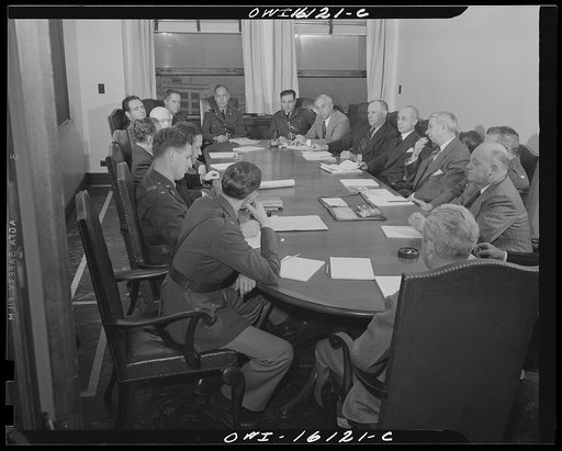 Untitled photo, possibly related to: Detroit, Michigan. Conference between U.S. Army ordnance and washing machine industry officials to determine the ability of manufacturers to produce parts needed by the Army. After inspecting samples, blueprints and prices were discussed