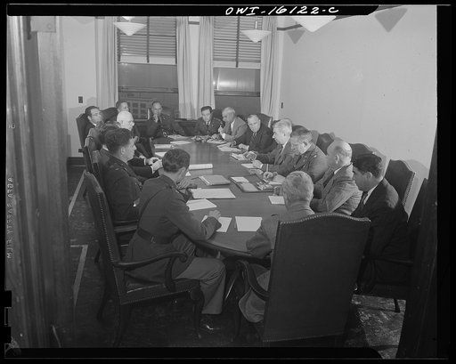 Untitled photo, possibly related to: Detroit, Michigan. Conference between U.S. Army ordnance and washing machine industry officials to determine the ability of manufacturers to produce parts needed by the Army. After inspecting samples, blueprints and prices were discussed