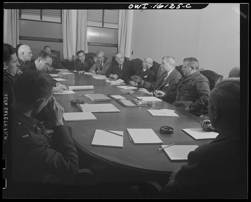 Untitled photo, possibly related to: Detroit, Michigan. Conference between U.S. Army ordnance and washing machine industry officials to determine the ability of manufacturers to produce parts needed by the Army. After inspecting samples, blueprints and prices were discussed