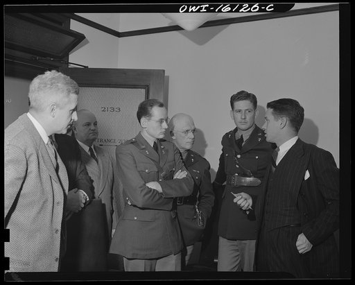 Detroit, Michigan. Conference between U.S. Army ordnance and washing machine industry official to determine the ability of manufacturers to produce parts needed by the Army. After inspecting samples, blueprints and prices were discussed