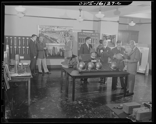 Detroit, Michigan. Conference between U.S. Army ordnance and washing machine industry official to determine the ability of manufacturers to produce parts needed by the Army. After inspecting samples, blueprints and prices were discussed. Inspecting objects to be manufactured