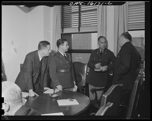 Detroit, Michigan. Conference between U.S. Army ordnance and washing machine industry officials to determine the ability of manufacturers to produce parts needed by the Army. After inspecting samples, blueprints and prices were discussed