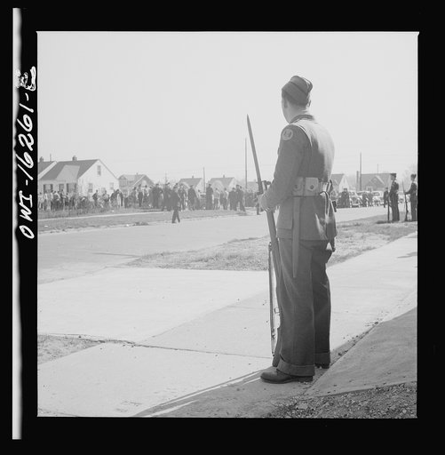 Detroit, Michigan. Riot at the Sojourner Truth homes, a new U.S. federal housing project, caused by white neighbors' attempt to prevent Negro tenants from moving in. Home guard soldier on duty