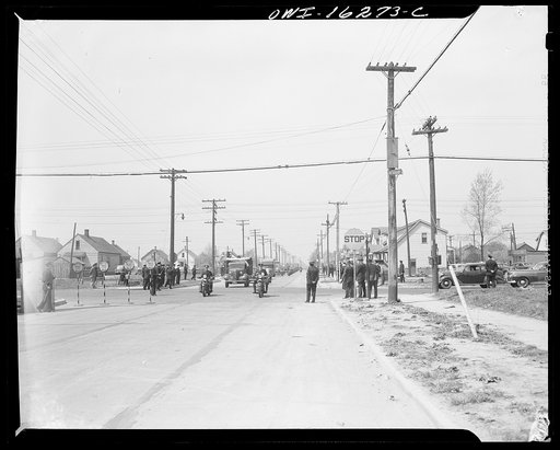 Detroit, Michigan. Riot at the Sojourner Truth homes, a new U.S. federal housing project, caused by white neighbors' attempt to prevent Negro tenants from moving in. Furniture vans under police convoy