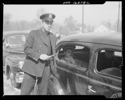 Untitled photo, possibly related to: Detroit, Michigan. Riot at the Sojourner Truth homes, a new U.S. federal housing project, caused by white neighbors' attempt to prevent Negro tenants from moving in. Arrested Negro with a policeman holding the knife he had been brandishing during the riot