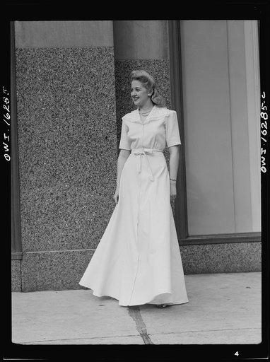 Fashion show presented by the Chrysler Girls' Club of the Chrysler Corporation at Saks Fifth Avenue store. Girl in a hostess gown