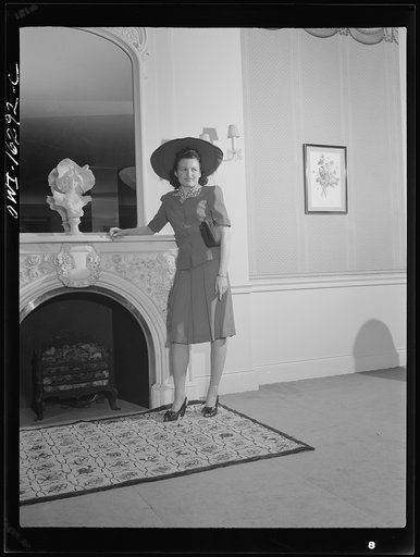 Untitled photo, possibly related to: Detroit, Michigan. Style show of clothes worn by better-dressed office workers, presented by the Chrysler Girls' Club of the Chrysler Corporation at Saks Fifth Avenue store. Girl admiring a mink coat