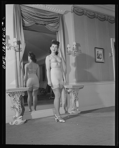 Untitled photo, possibly related to: Detroit, Michigan. Fashion show presented by the Chrysler Girls' Club of the Chrysler Corporation at the Saks Fifth Avenue store. Girl modeling a brassiere and girdle