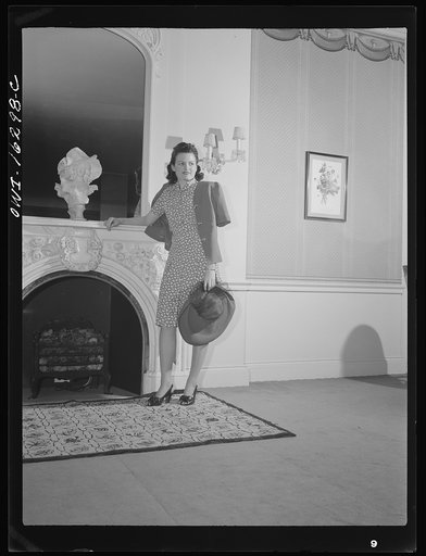 Untitled photo, possibly related to: Detroit, Michigan. Style show of clothes worn by better-dressed office workers, presented by the Chrysler Girls' Club of the Chrysler Corporation at Saks Fifth Avenue store. Girl admiring a mink coat
