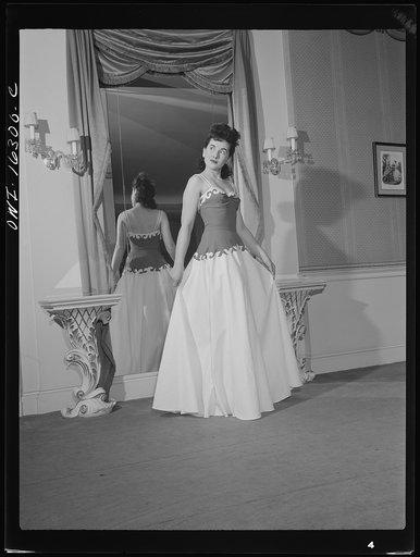 Untitled photo, possibly related to: Detroit, Michigan. Fashion show presented by the Chrysler Girls' Club of the Chrysler Corporation at Saks Fifth Avenue store. Girl modeling a summer formal grown