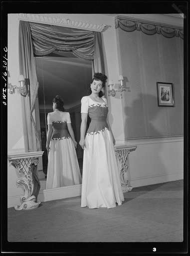 Detroit, Michigan. Fashion show presented by the Chrysler Girls' Club of the Chrysler Corporation at Saks Fifth Avenue store. Girl modeling a summer formal grown