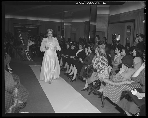 Detroit, Michigan. Fashion show presented by the Chrysler Girls' Club of the Chrysler Corporation at Saks Fifth Avenue store. Chrysler girls watching a model