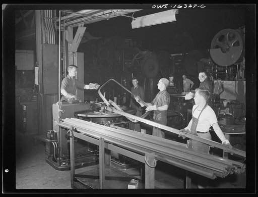 Dearborn, Michigan. Workers in the River Rouge Ford plant bending metal strips to form window frames for automobiles