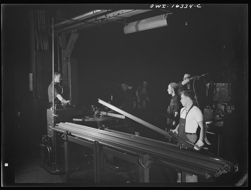 Untitled photo, possibly related to: Dearborn, Michigan. Workers in the River Rouge Ford plant bending metal strips to form window frames for automobiles